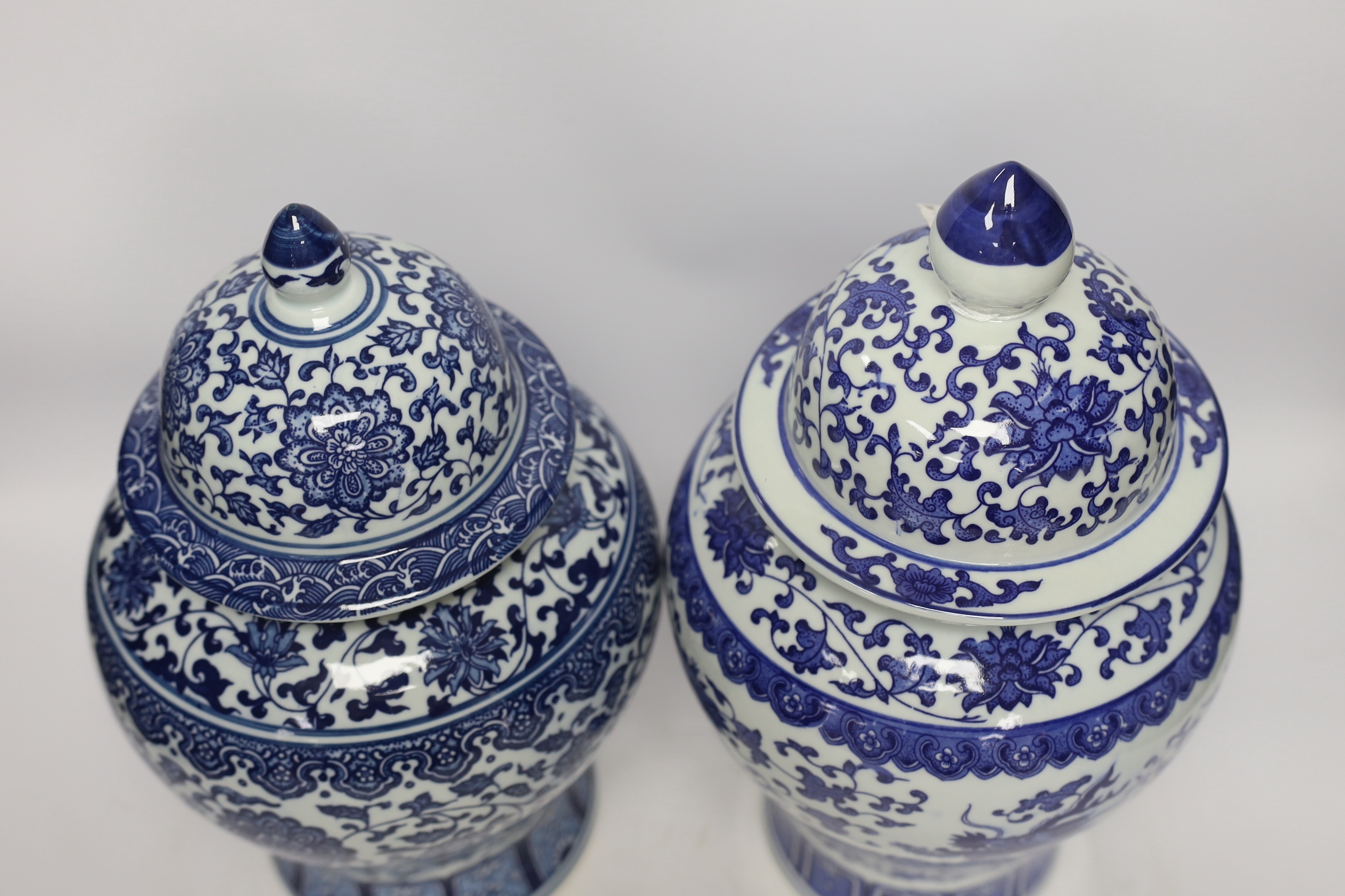 Two Chinese blue and white vases and covers, 38cm high